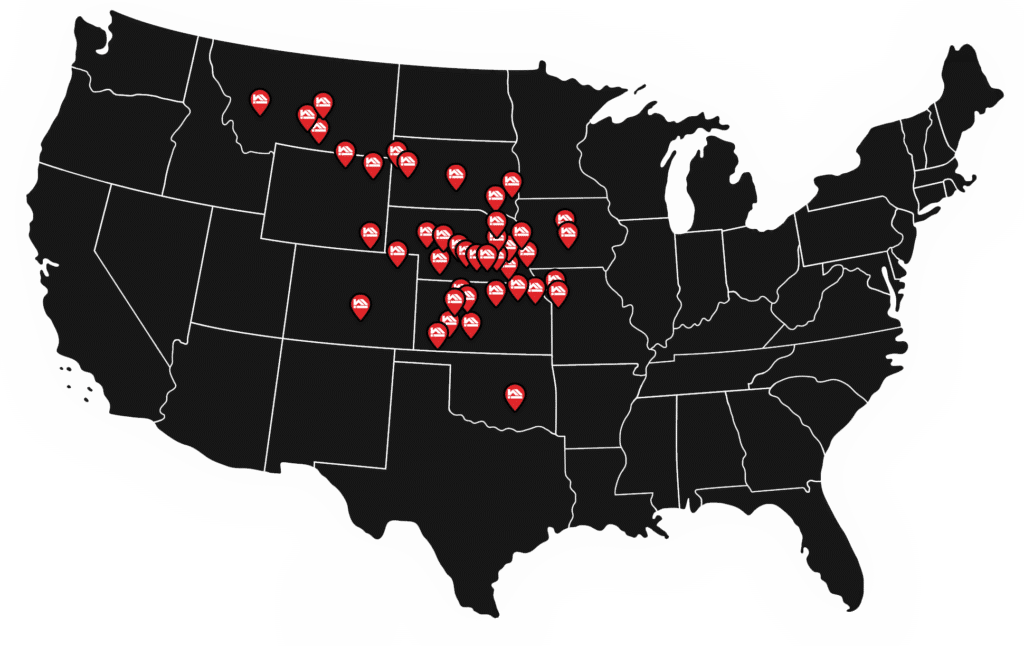Black US map illustration with white lines on borders of each state, and red and white location pins depicting Mead Lumber location cities.
