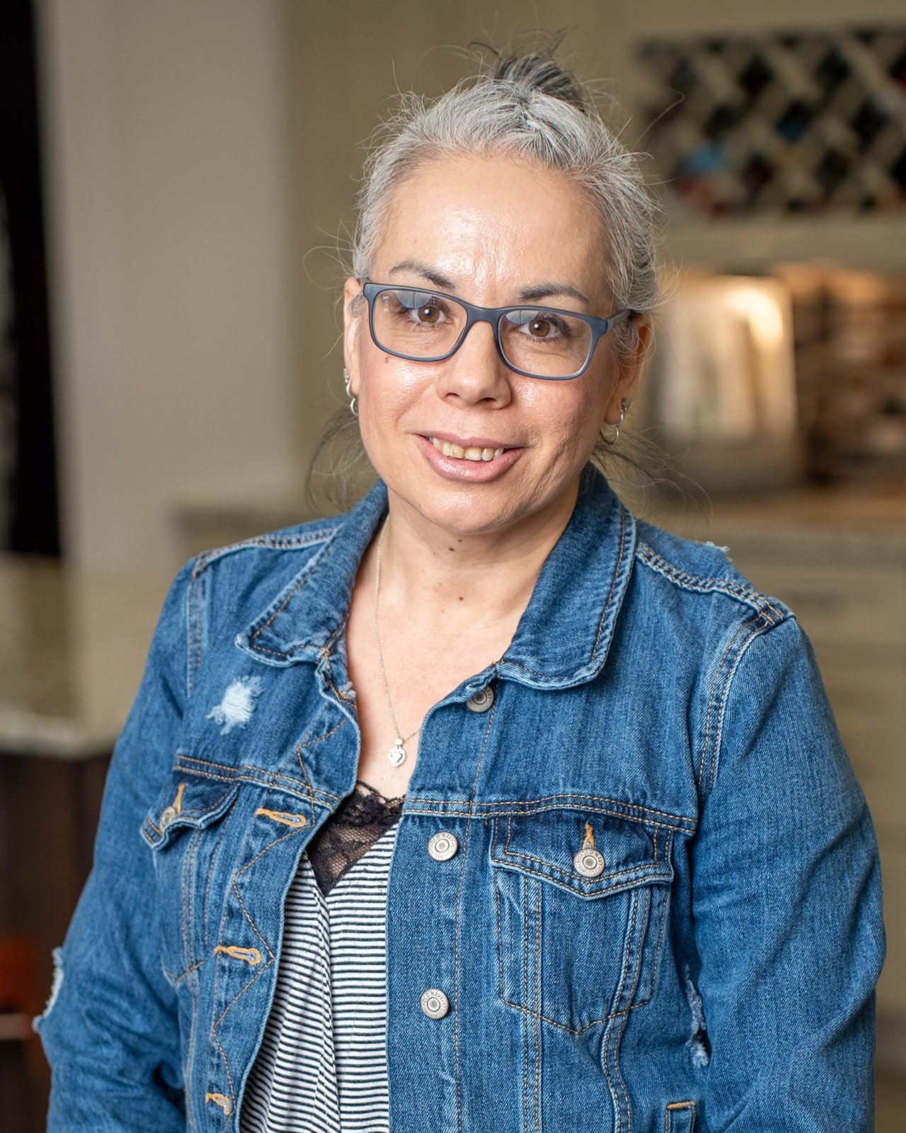 Mead Lumber of Liberal Store Manager headshot. She has gray hair and wearing blue framed glasses and a denim jacket.
