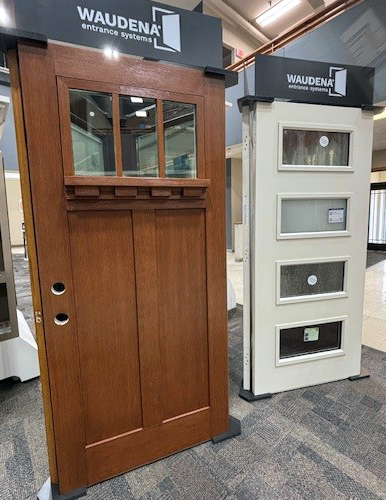 Door display of Waudena brand mission style with 3 windows at the top and a white modern style door with 4 horizontal windows.